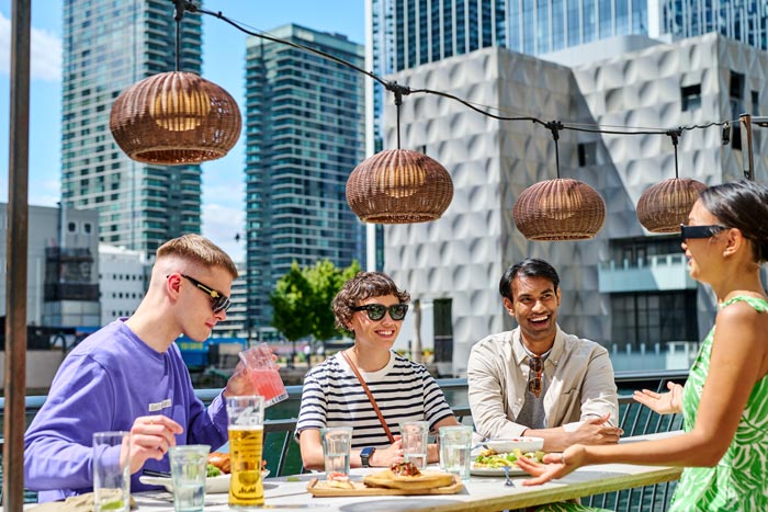 Friends enjoying having meals outdoors