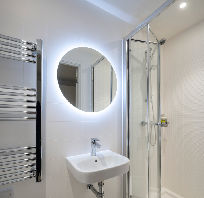 Washroom with backlit mirror in Vertus edit hotel