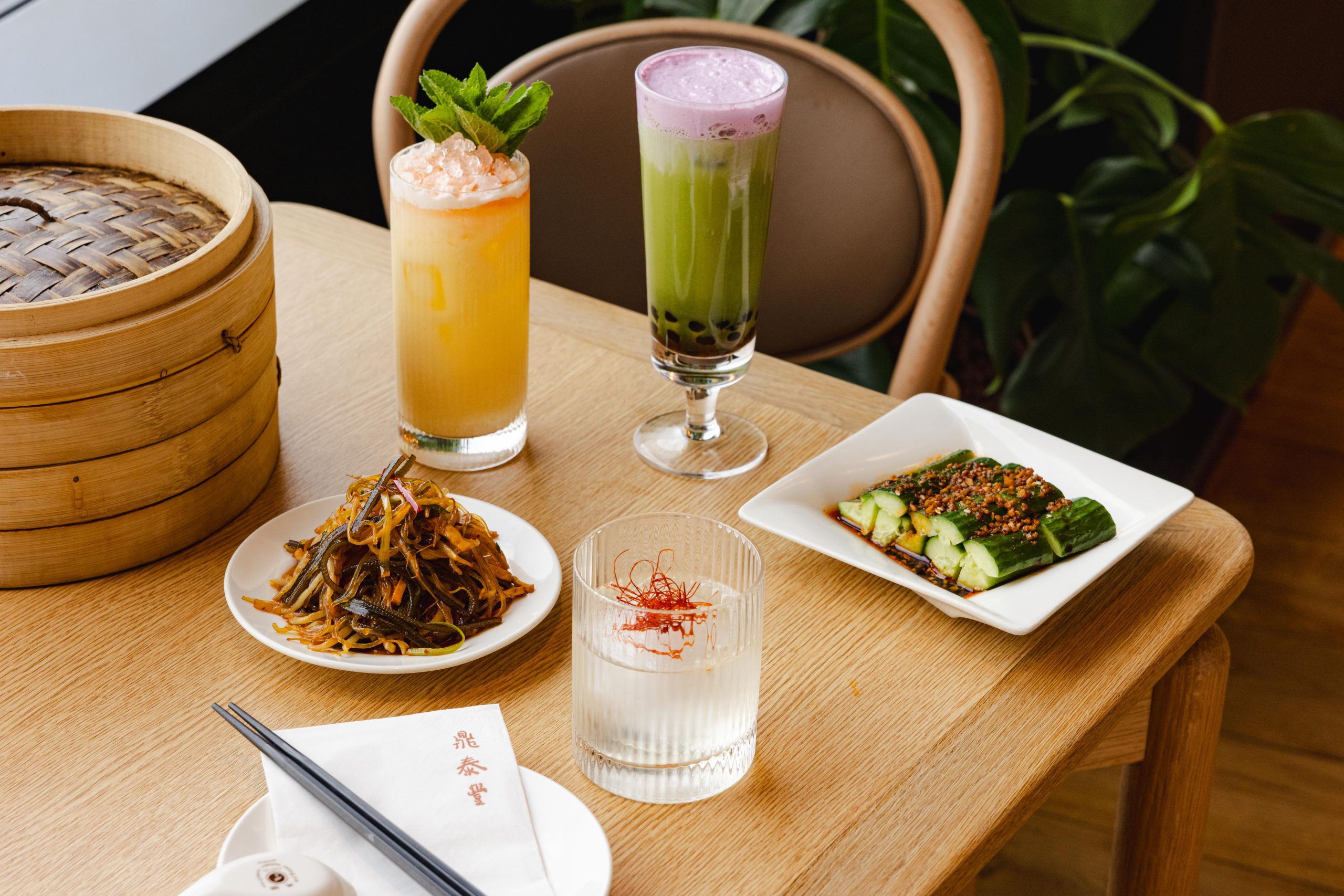Cocktail and small plates on table