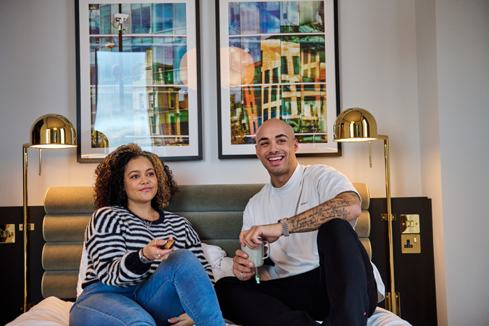 Couple enjoying modern, comfortable rooms in canary wharf