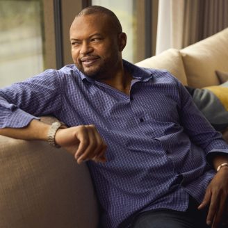 man sitting on sofa looking out window