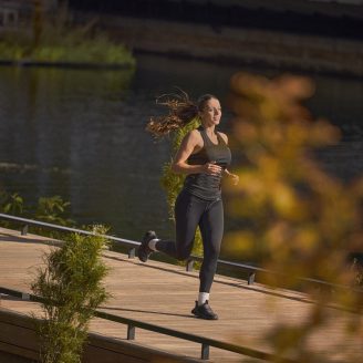 Girl running by water
