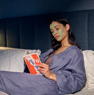 Women with facemask lying on bed