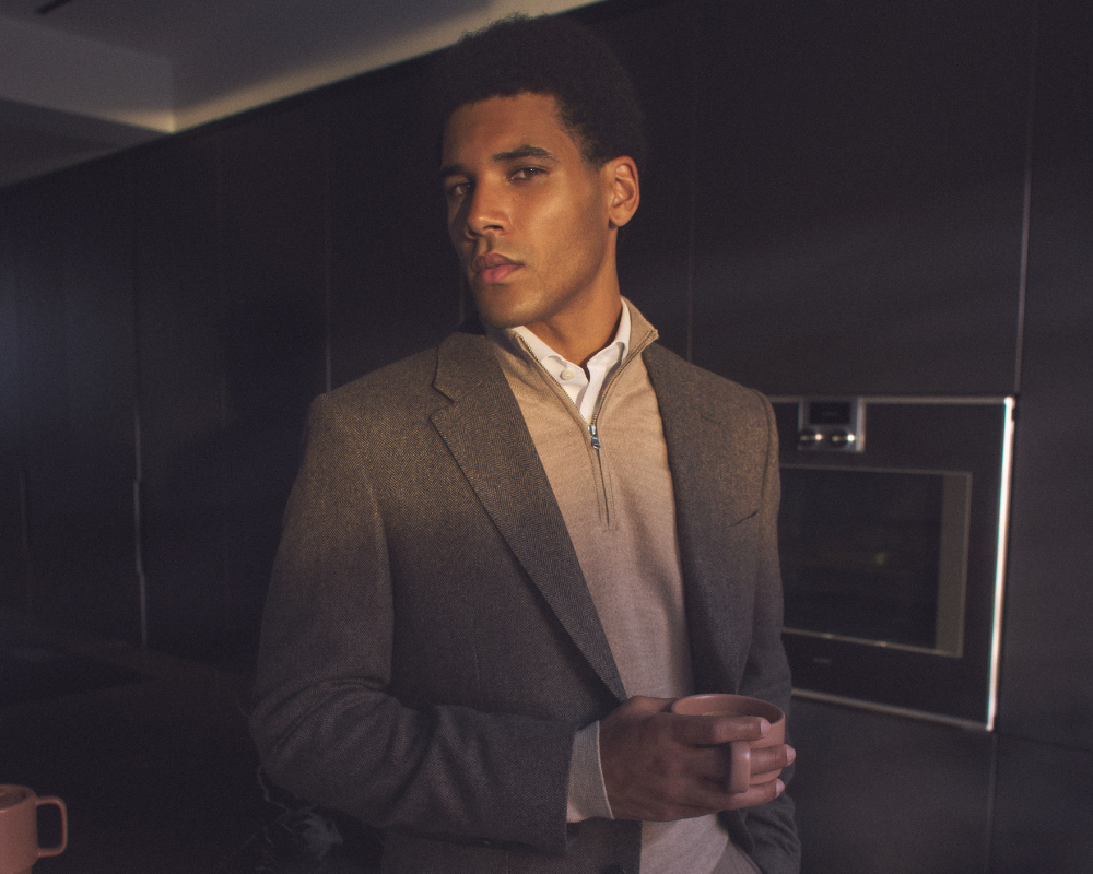 man in suit with quarter zip jumper